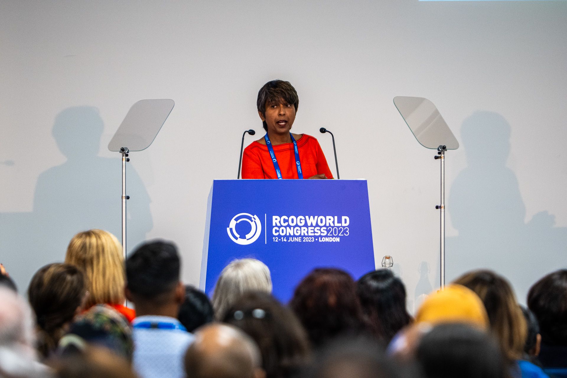 Professor Shakila Thangaratinam stood on RCOG World Congress 2023 podium addressing audience.