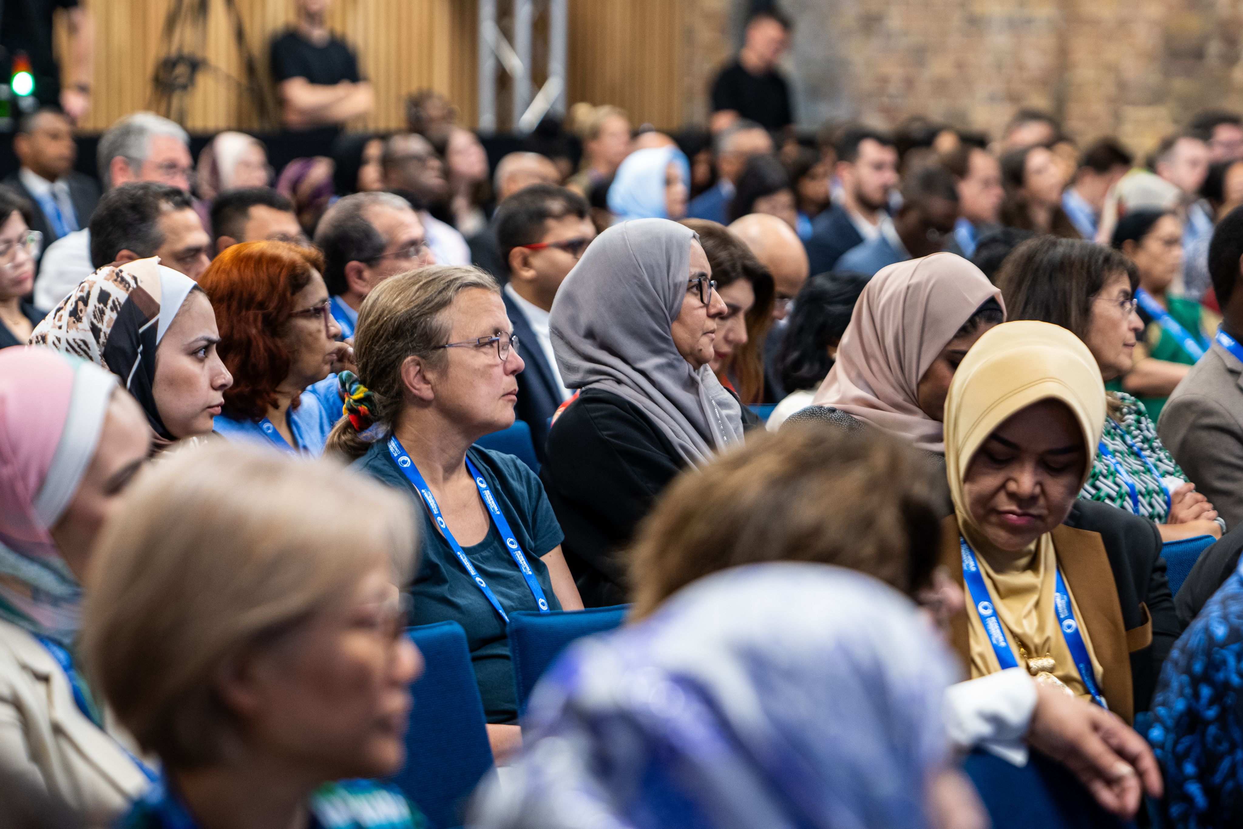 Audience wearing RCOG World Congress 2023 lanyards in auditorium at RCOG Union Street building.