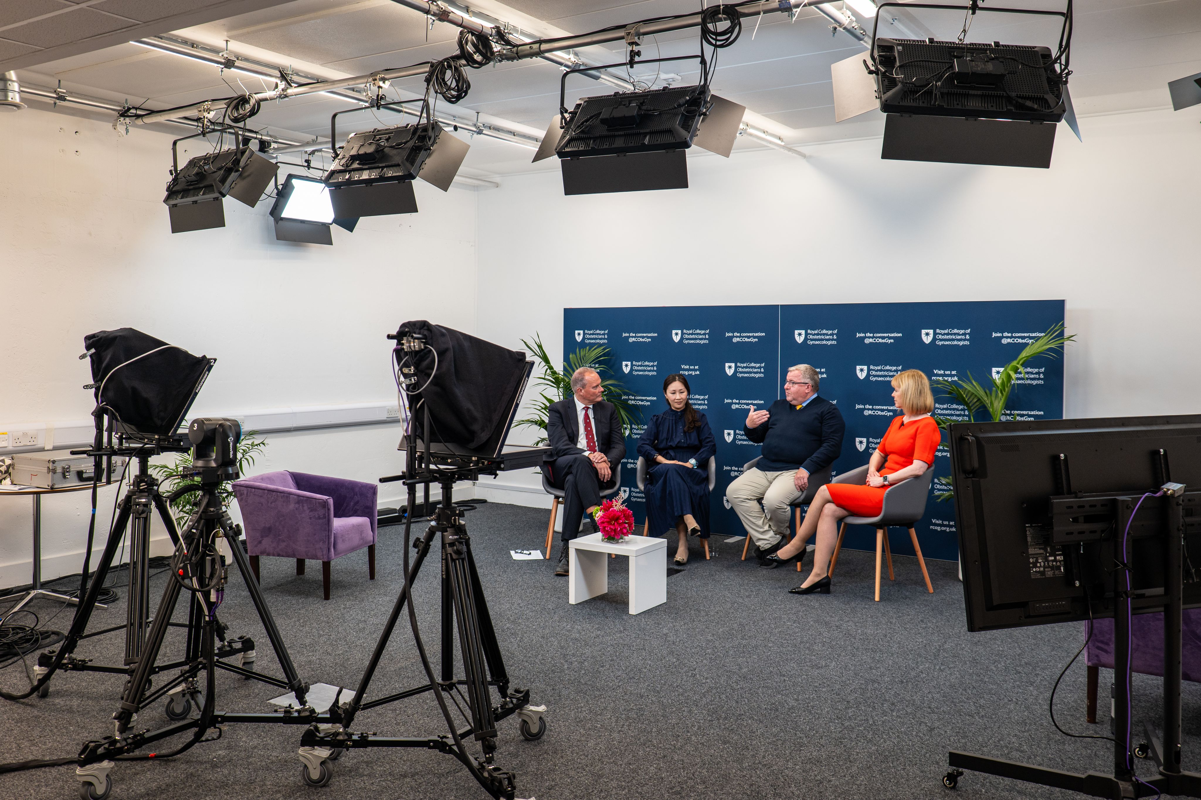 Kate Lancaster, CEO RCOG, speaking with three other people as they are filmed in the RCOG studio.