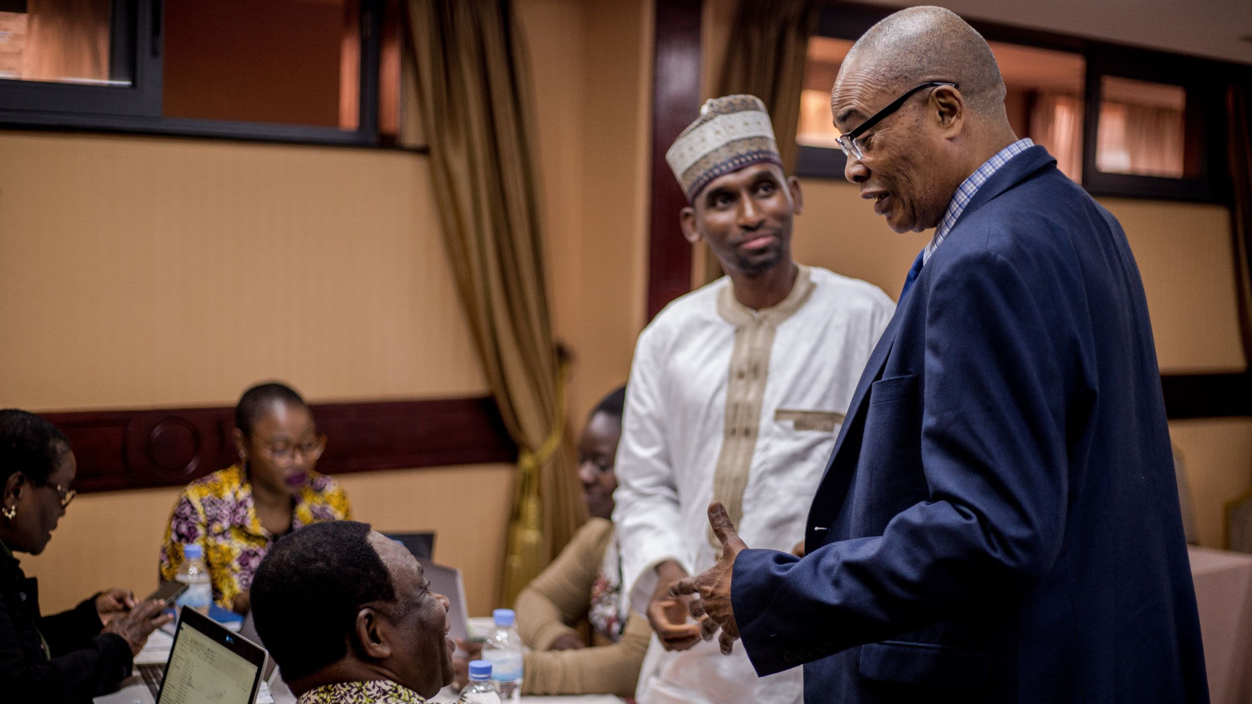A photo of two men speaking at a meeting in Rwanda for the Making Abortion Safe programme