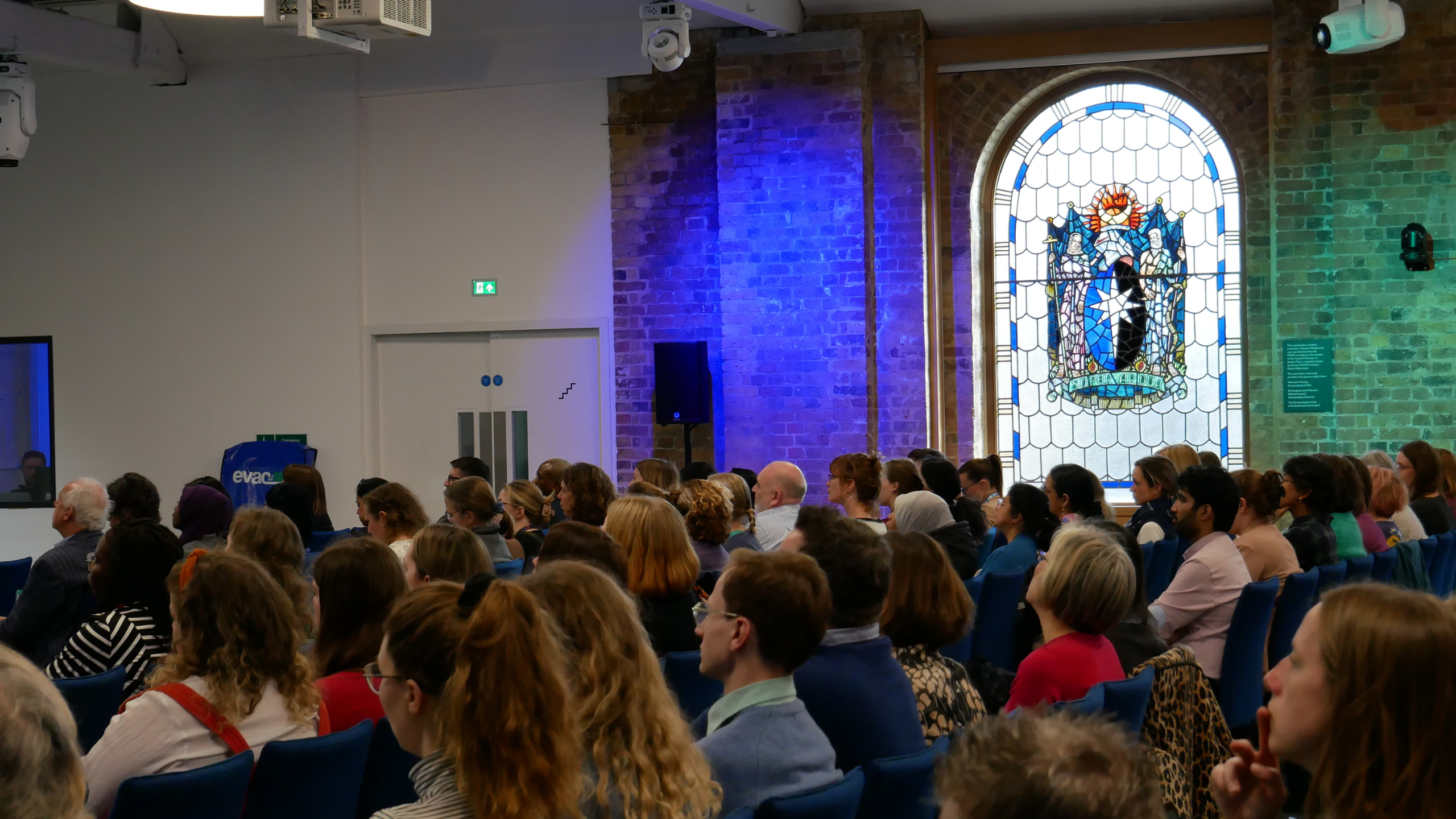 The audience at an event, with the RCOG stained glass window in the background