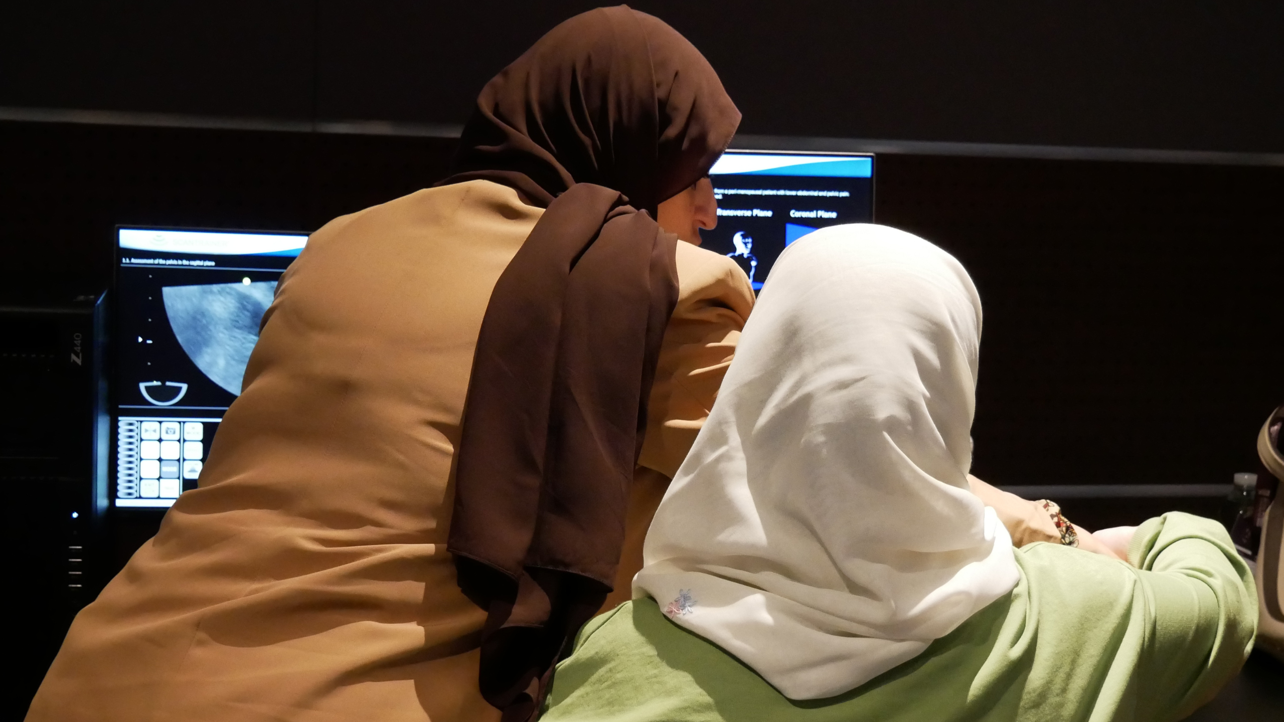 Two women at a workshop at RCOG World Congress 2024. They are both wearing a headscarf.