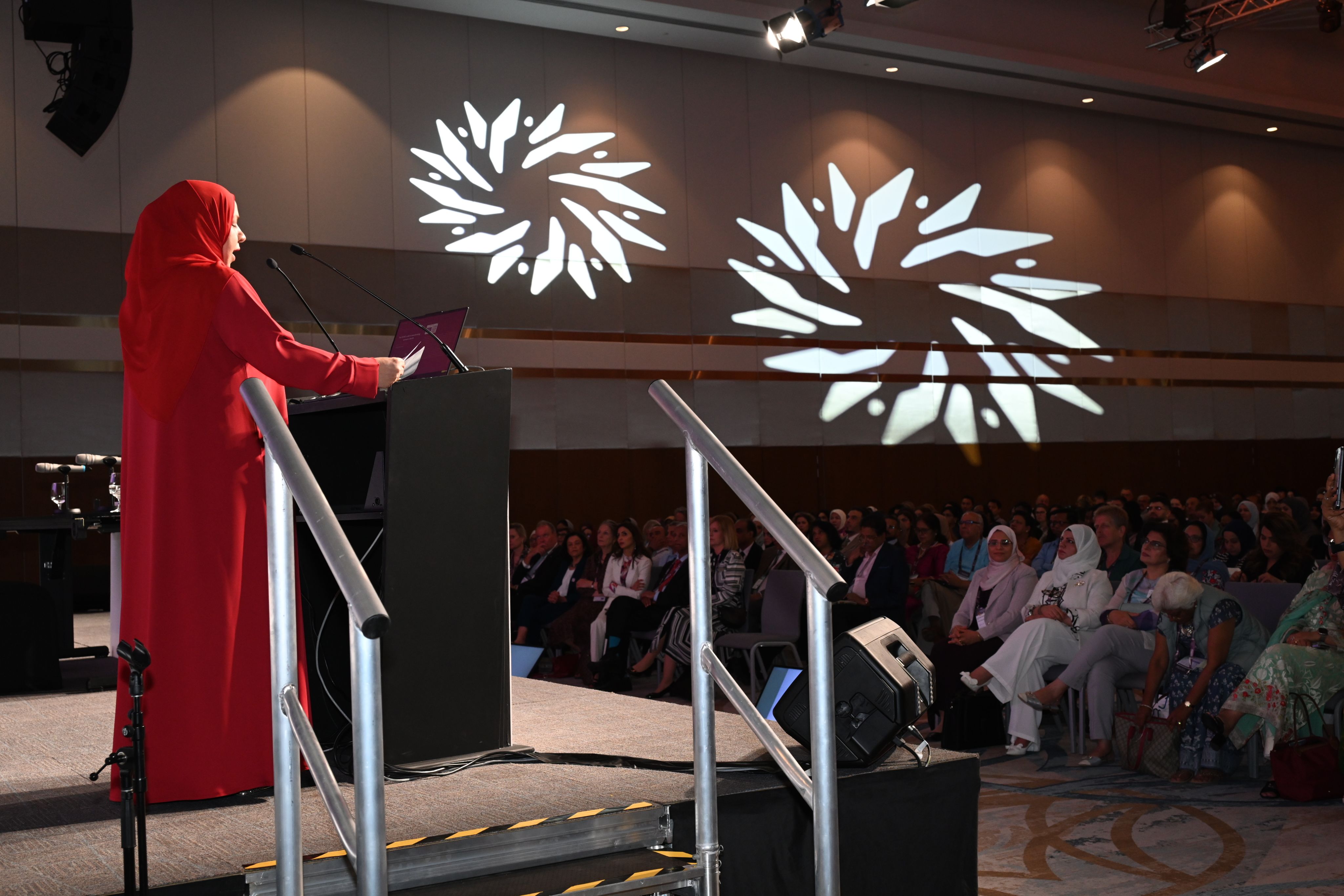 Dr. Tamima Rashid Al Dughaishi on stage at RCOG World Congress, facing the audience